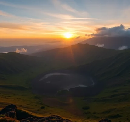 Majestic Mount Rinjani volcano with lush slopes and crater at dawn, showcasing Indonesia's natural beauty.